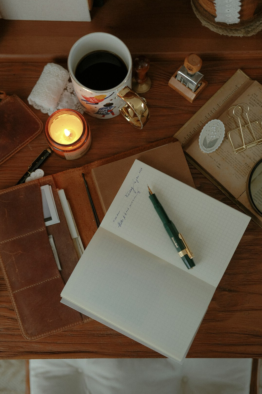 Open notebook with handwritten notes and pen on a wooden desk